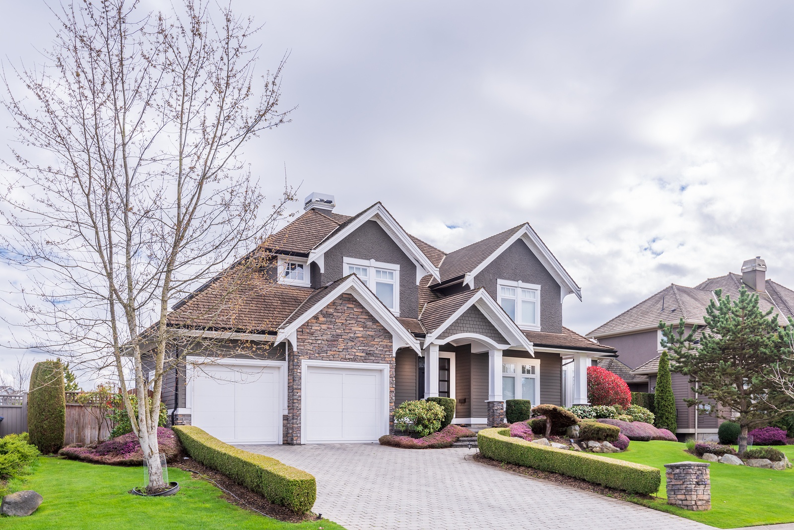 Beautiful exterior of newly built luxury home. Yard with green g